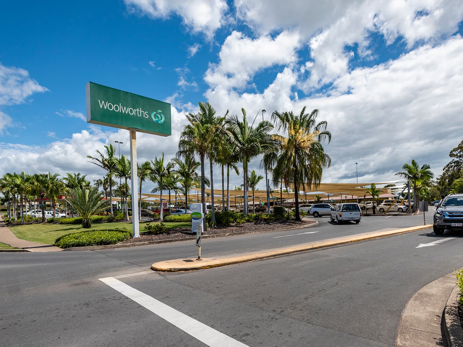 Urangan Central car park with the Woolworths pylon sign and palm trees