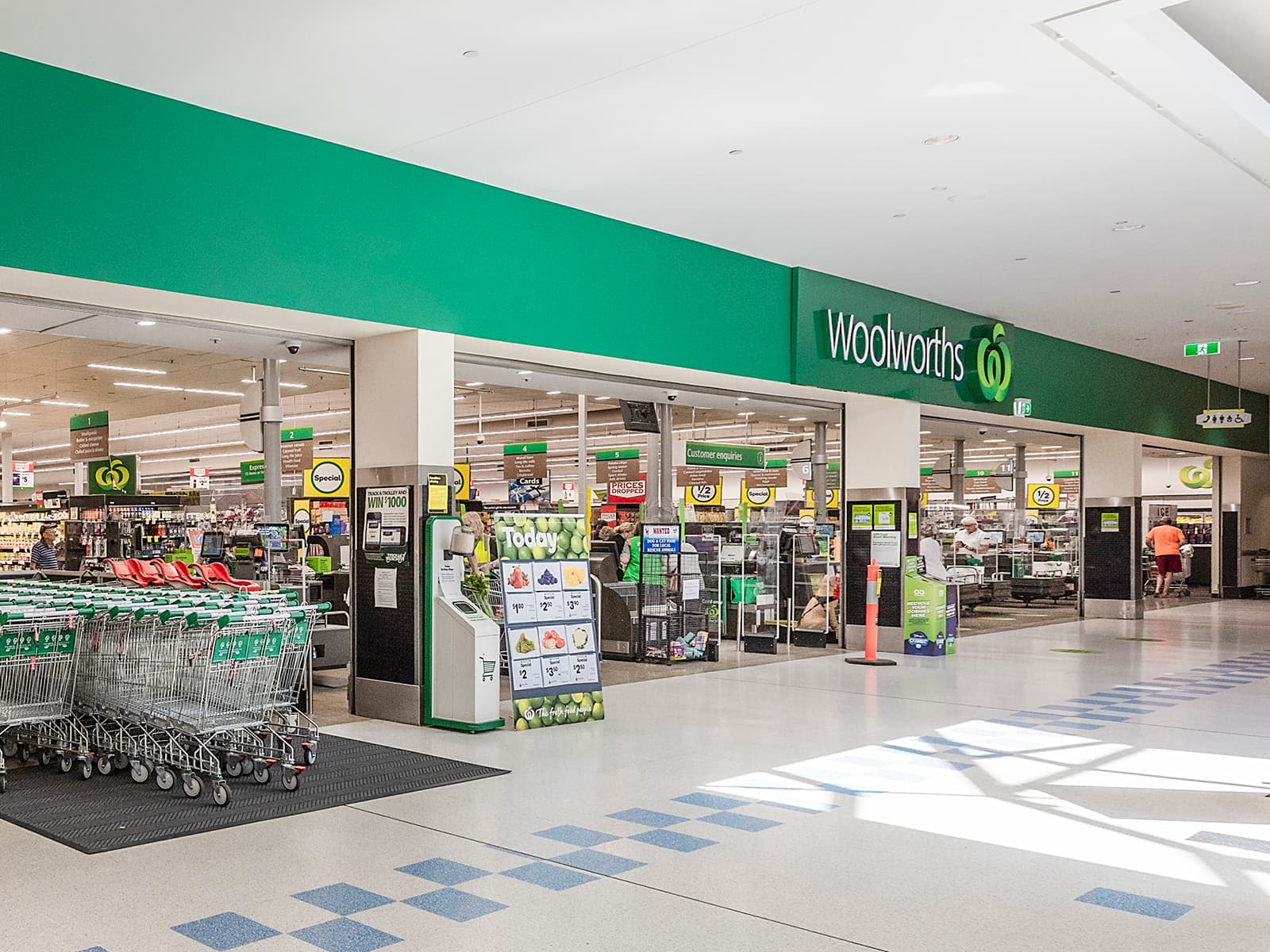 Woolworths entrance inside Urangan Central with trolleys and the store front