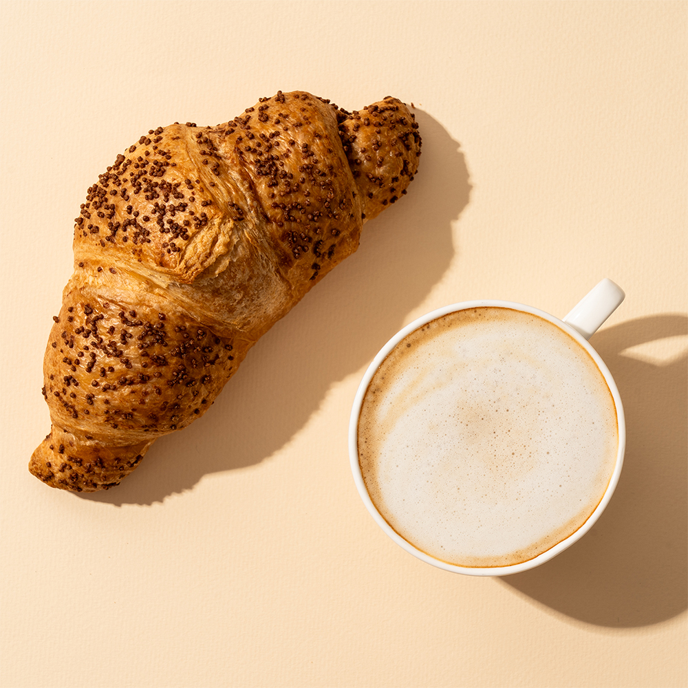 Croissant and cappuccino on a table