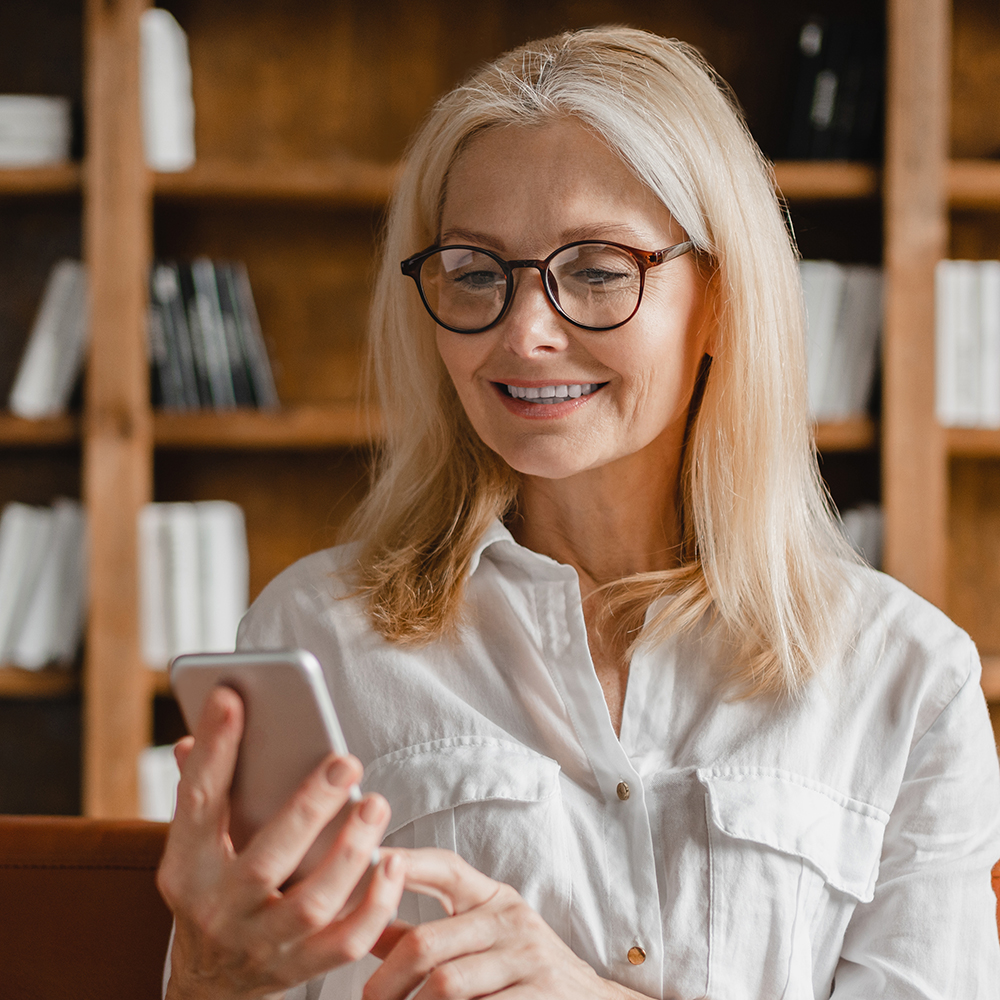 Smiling woman reading on her phone